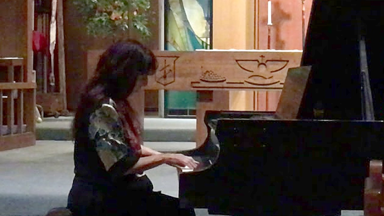 Mary playing piano in a church, from the Savlanut video